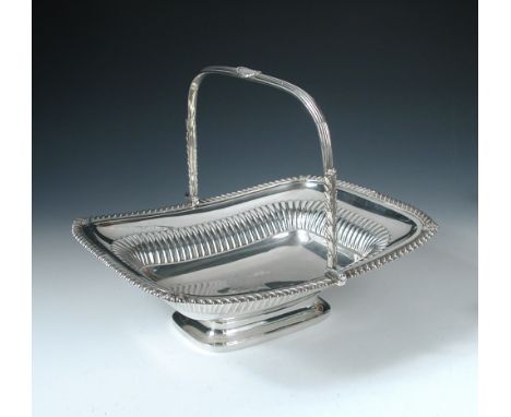 A Regency silver cake basket, by Paul Storr, London 1816, of rectangular shape, the body part fluted within a gadrooned edge,
