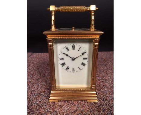 A French gilt brass carriage clock with repeat, the pillared case with silvered platform lever escapement and painted dial 15