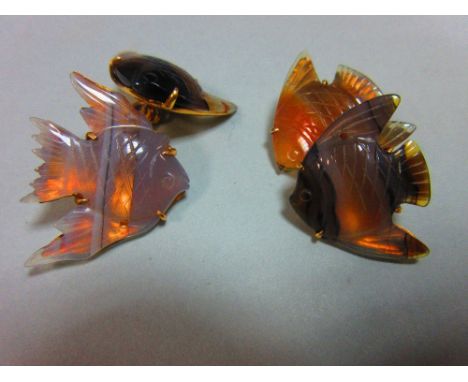 A pair of carved agate angel fish double ended cufflinks, each shaped piece of translucent banded agate carved in low relief 