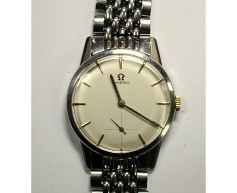 By Omega - a gentleman's steel cased manual wind wristwatch, circa 1960's, champagne coloured dial with gold coloured baton n
