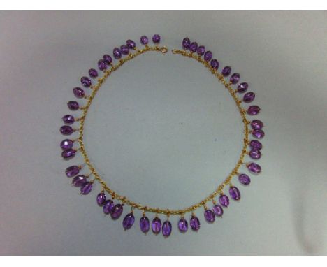 An amethyst fringe necklace, the unmarked yellow precious metal belcher link chain suspending evenly along its complete lengt