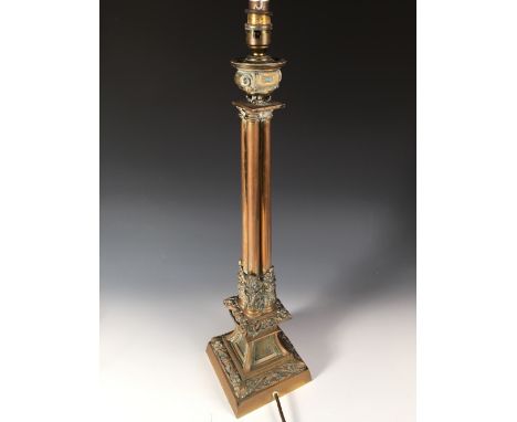 A 19th century gothic brass column lamp later converted as an electric lamp, the bowl nozzle on four gun barrel columns flari
