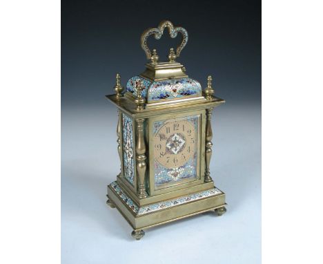 A late 19th century brass and enamelled mantle clock, with folding handle above repeat button, double baluster column corners