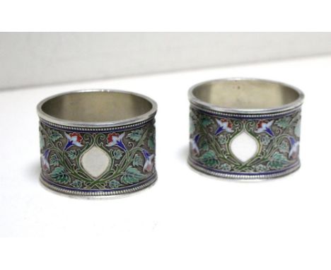 Two Russian silver and cloisonné enamel napkin rings. by Grachev, St Petersburg, 1896 (88 zol.), each of oval section, the gr