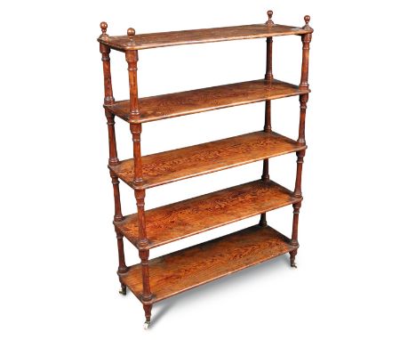 A late 19th century Oregon pine shelf, of five open tiers, with turned finials and on turned feet and casters 110 x 76 x 27cm