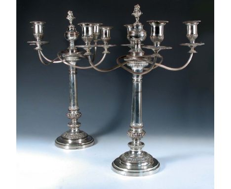 A very large pair of Old Sheffield plate candelabra, by Matthew Boulton, the bases rising from a stepped circular foot decora