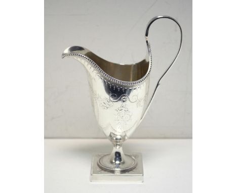 A George III silver creamer, by Hester Bateman, London 1786, of helmet shape, the body engraved with festoons and flowers bel