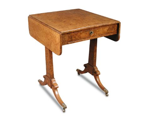 A late Regency burr walnut sofa table, with single drawer, on standard end supports with fret carved gothic quatrefoil and ca