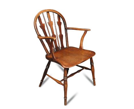 An early 19th century ash and fruitwood Windsor armchair, with fret carved and stick back, on turned legs 88 x 53cm (34 x 21i