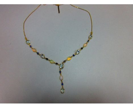 An 18ct gold opal, sapphire and aquamarine necklace, set to the front with an articulated line of spectacle set oval and cush