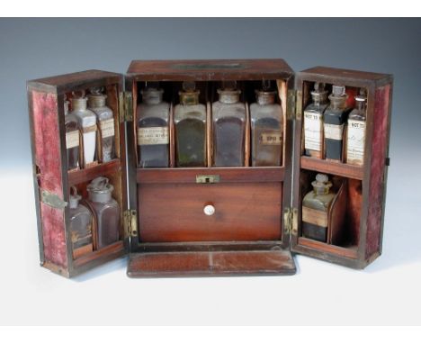 A 19th century mahogany apothecary's chest, the thirteen bottles mainly bearing labels for 'R Hempstead, St Leonards on Sea',