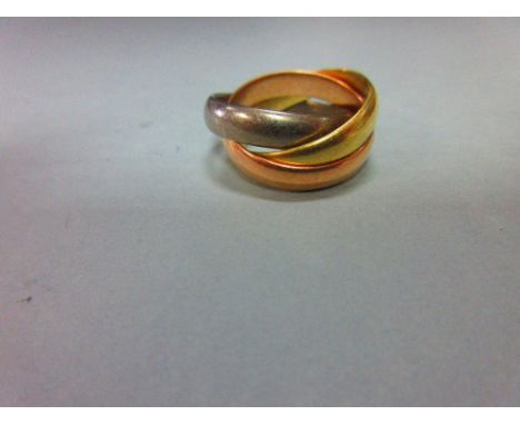 An 18ct three colour gold 'Russian wedding' ring, the three interlocking plain D-section bands, one each of yellow, rose and 