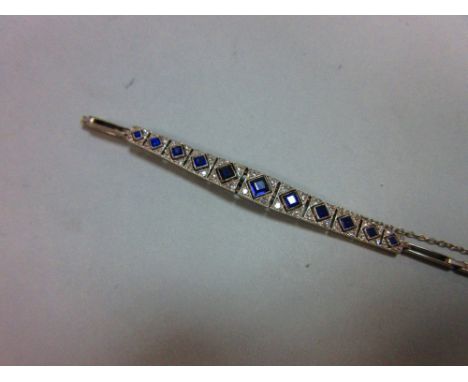 An Art Deco sapphire and diamond bracelet, set to the centre with an articulated and graduated line of millegrain edged, pier