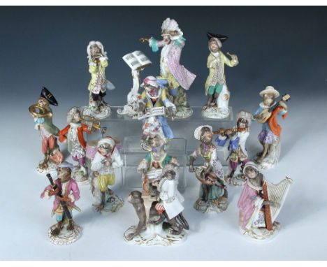A Meissen fifteen piece monkey band, each of the figures singing or playing an instrument, a drummer beating the drums held b