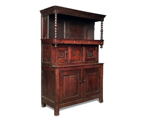 A late 17th century oak tridarn, with open front overhung shelf to the top supported by turned columns above a second tier wi