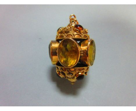 An ornate citrine set pendant, designed as five oval cut and collet set lemon citrines forming a hollow ring, with matching b