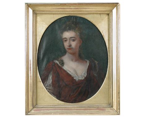 Circle of Sir Godfrey Kneller (British, 1646-1723) Portrait of a lady in a red dress with lace fichu oil on canvas, oval 57 x