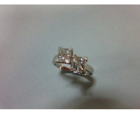 A certificated two stone princess cut diamond and platinum ring, the two beautifully matched stones, four claw held and verti