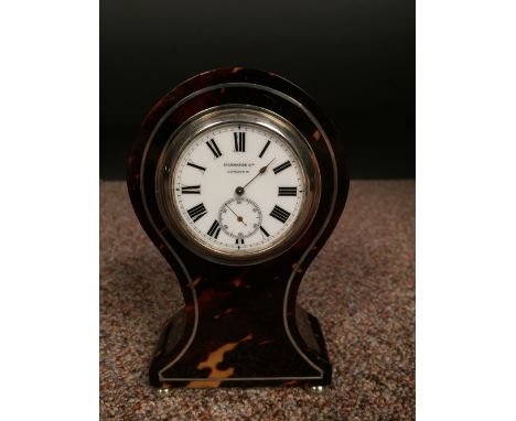 An Edwardian small size tortoiseshell mantle clock, the balloon shape case with 4.5cm (2in) enamel dial marked for Harrods Lt