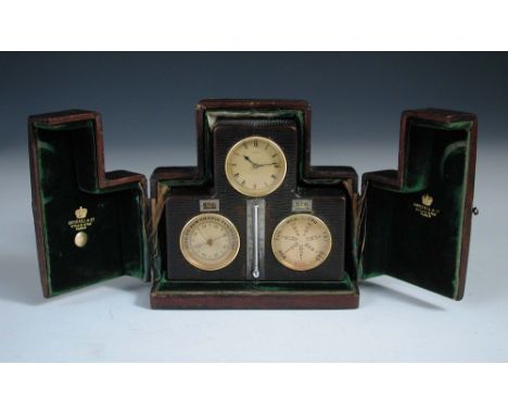 A Swiss leather cased desk timepiece with calendar and barometer, mounted with central silvered scale thermometer, the dial m