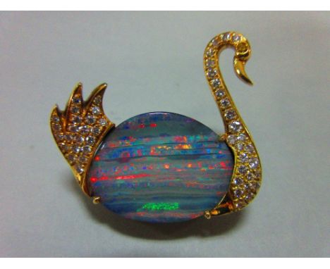 An opal and diamond brooch in the form of a swan, the body of the swimming bird formed by an ovoid flat cabochon grey opal st