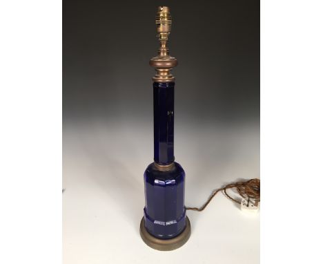 A Victorian blue glass table lamp, the octagonal column above a broad base and brass mounts, converted for elecricity 56cm (2