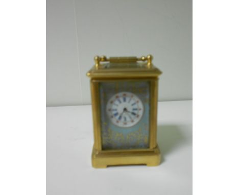 A miniature French porcelain panel gilt brass carriage timepiece, with gilt decorated pale blue surround to the enamel 2cm (.