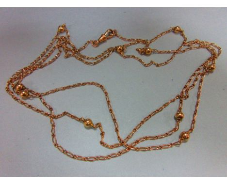 A fancy link long chain, composed of alternating long and short fine curb links, spaced at intervals with spherical beads, wi
