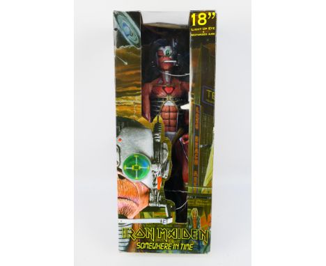Neca - A boxed Iron Maiden Somewhere In Time figure with light up eye and motorized arm. The figure appears Mint, the box has