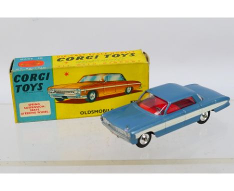 Corgi - A boxed Oldsmobile Super 88 sedan in light blue # 235. A few light marks including to  the passenger window, and the 
