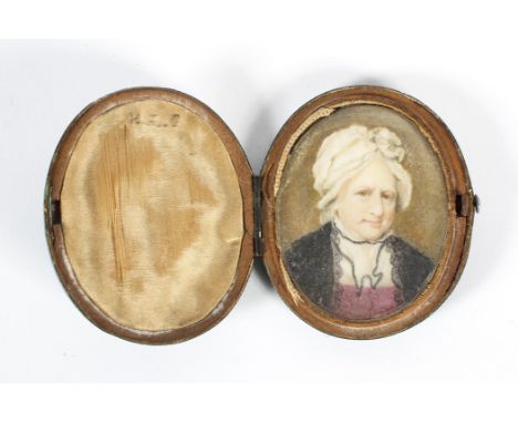 A 19th century portrait miniature of a lady wearing a mop cap and black lace, in shagreen-style oval case, 6 cm wide 