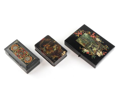 Two Victorian papier mache snuff or box/stamp boxes and hinged covers and another similar inlaid example, the largest decorat