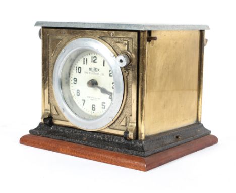 An early 20th century vintage Blick time recorder, brass cased with enamel face, mounted on a mahogany plinth, 19cm high x 23