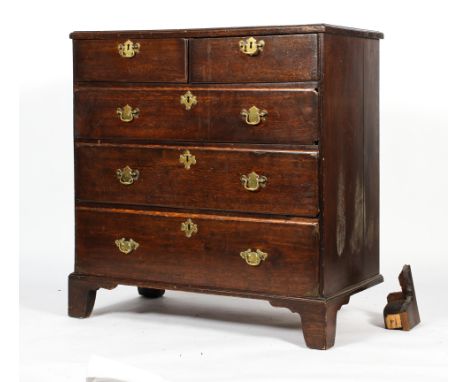 A Georgian oak chest of two short and three graduated long drawers, with brass swing pulls and bracket feet, 96cm high x 93cm