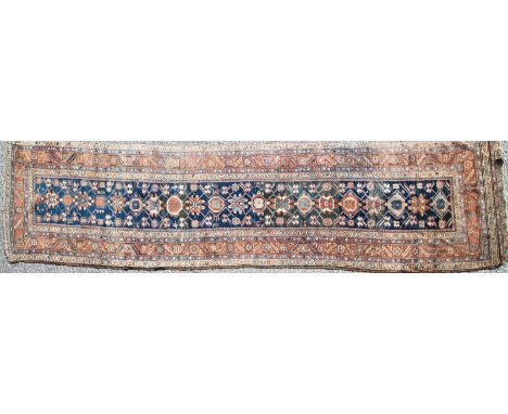 A North West Persian Runner, the indigo lattice field of flower heads enclosed by terracotta borders or rosettes, 450cm x 96c