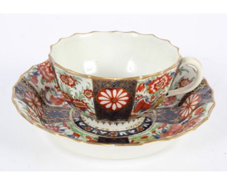 A Worcester Teacup and Saucer, of Warmstry Fluted form, in a Japan pattern, square seal marks, saucer 13.5cm diameter