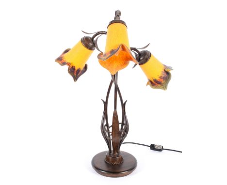 An Art Nouveau style three light lamp, each mottled orange flower bud shade on a bronzed foliate stem, total height 63cm