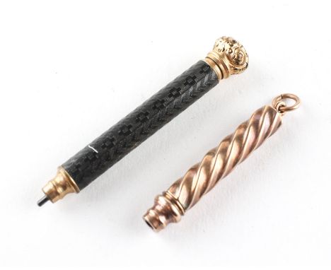 Two yellow metal propelling pencils, the first of spiral form, the second with engine turned ebonised   decoration, 6.5 cm lo