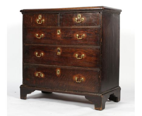 An 18th century oak chest of drawers, comprising two short drawers above three long graduated drawers, on ogee bracket feet, 