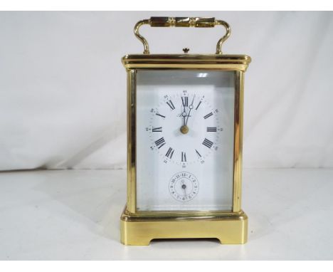 A French brass cased gong striking carriage clock with alarm, Roman numeral enamel dial with outside minute track and blued s