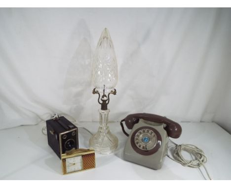 A mixed lot to include a Swiza coral four jewel wind up alarm clock, a Balda rollbox camera, vintage telephone and a glass ta