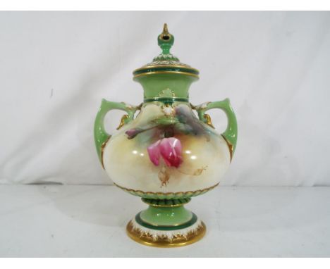 Royal Worcester - A large, lidded, twin handled pedestal vase decorated with roses on a white ground with gilded details, sta