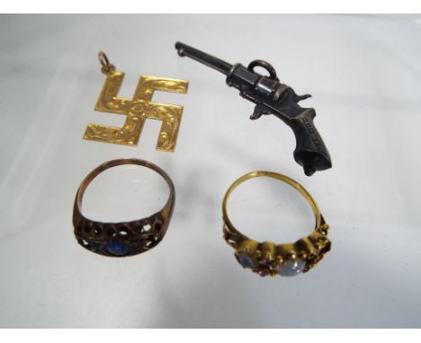 A hallmarked 9ct gold ring set with sapphire, a 9ct gold pendant, a yellow metal ring stone set (unmarked) and a hallmarked s