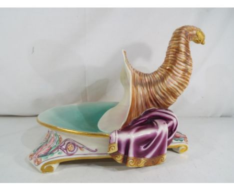 Royal Worcester - An unusual Royal Worcester bowl / centrepiece in the form of a dish on tripod feet surmounted with a large 