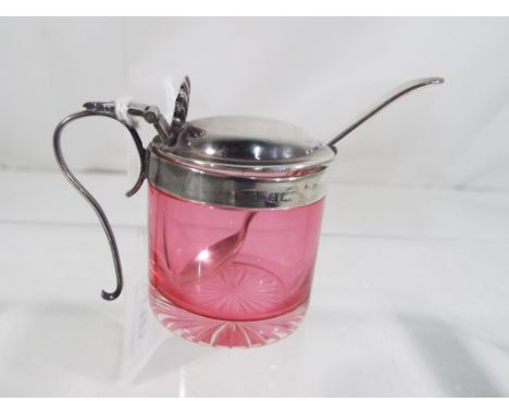 An Edward VII cranberry glass and silver hallmarked mustard pot, Birmingham assay 1908, with a George V spoon Birmingham assa