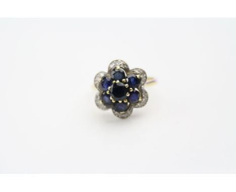 Sapphire and diamond 18ct yellow gold white gold set flower head ring, seven round mixed cut sapphires, claw settings, small 