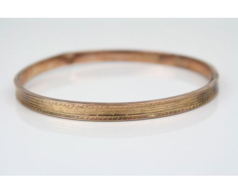9ct rose gold slave bangle, bright cut repeating decoration, width approximately 5.5mm (af)