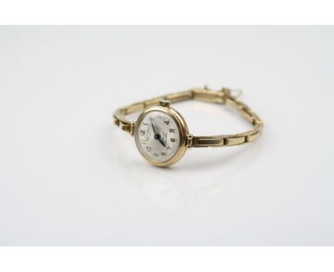 Rotary ladies 9ct yellow gold wristwatch, champagne dial, gilt Arabic numerals, black pencil hands, on 9ct gold bracelet stra