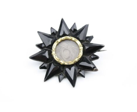 Early Victorian French jet yellow metal star brooch, sixteen star rays, hair panel to centre with cast yellow metal surround,