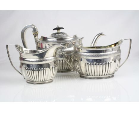 Matched three piece silver tea service comprising teapot, milk jug and twin handled sugar bowl, gadrooning to lower half and 